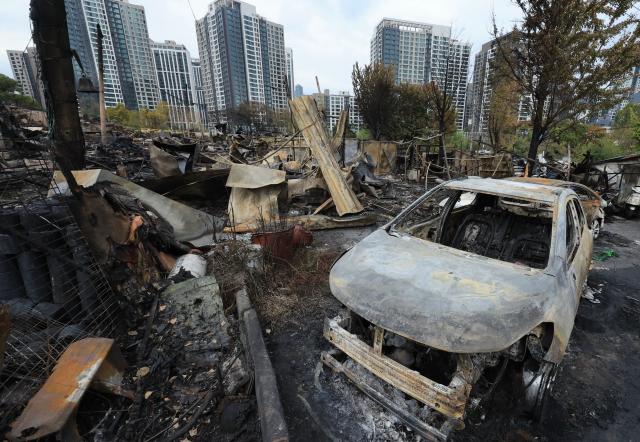 A day after the fire: Guryong Village in the aftermath